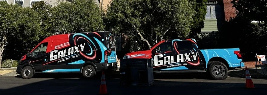 Galaxy-branded service van and pickup truck parked together on a tree-lined street